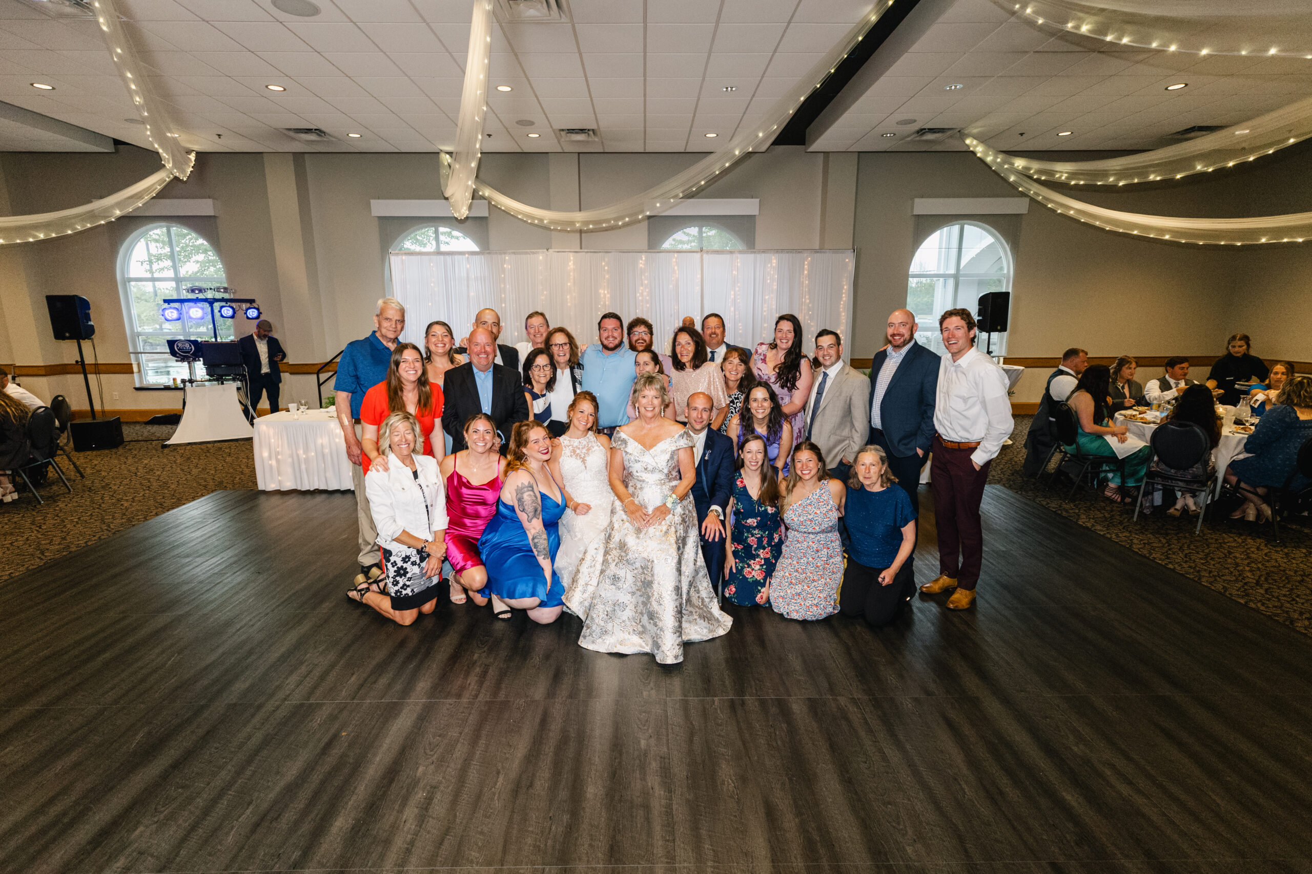 Bride and groom with family at wedding reception at Ceruti's venue in Fort Wayne, Indiana.