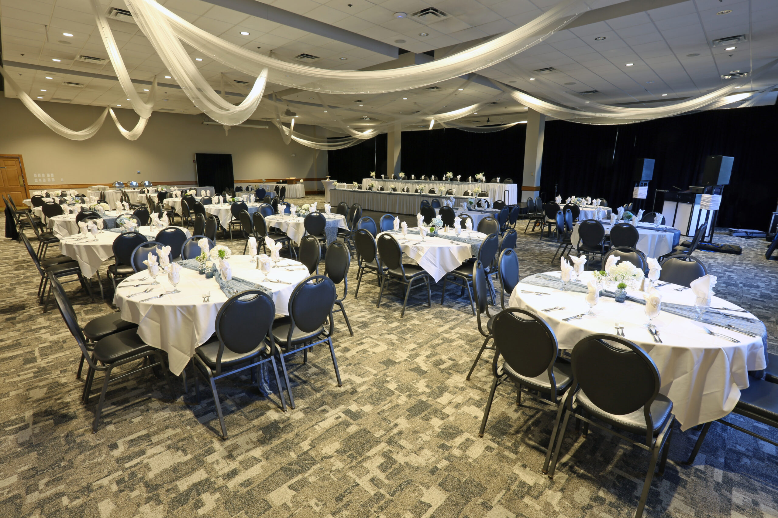 Summit Room wedding reception venue at Ceruti’s Summit Park in Fort Wayne, featuring white table linens, elegant ceiling draping, and banquet seating.